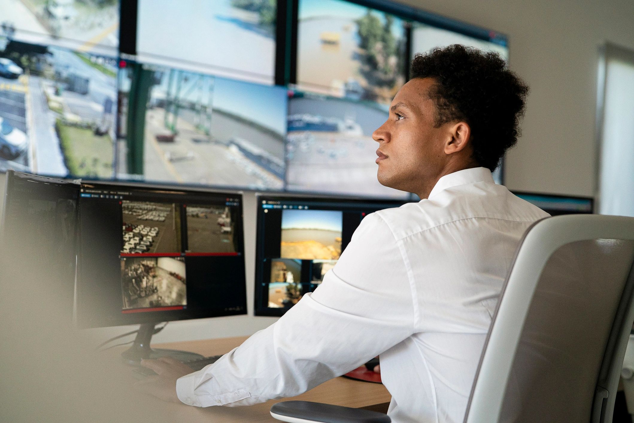 Security professional monitoring systems representing cybersecurity oversight