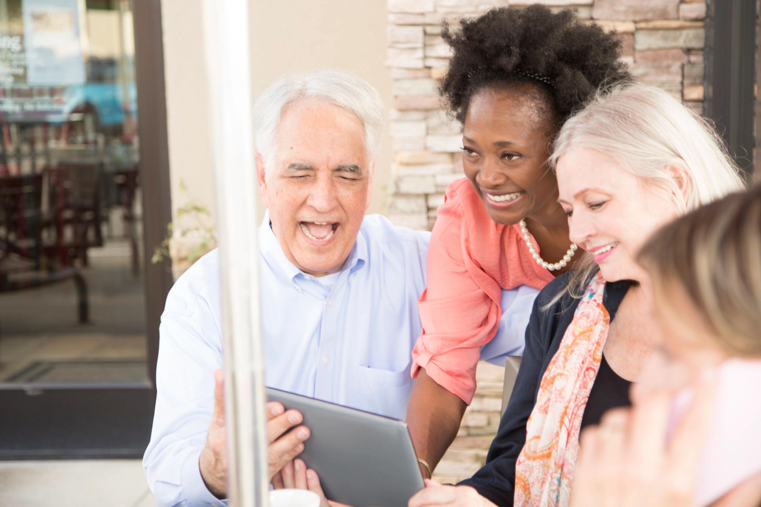 Smiling senior adults using a tablet